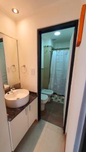 a bathroom with a sink and a toilet at Rialto Departamentos Amplios luminosos Cochera y asador in Villa Mercedes