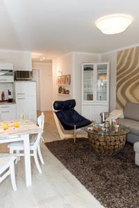 a living room with a couch and a table at Whg 11 - Sonnencamp in Zingst