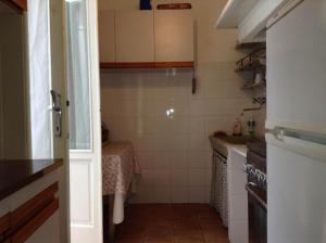 a small kitchen with a sink and a stove at Casa Sara in Viareggio +8 photos