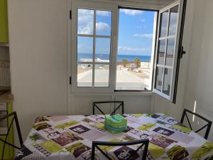 a table with a view of the ocean from a window at Aires de Mar in Playa Honda