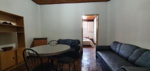 a living room with a couch and a table at Apart Hotel Flomon in Ouro Preto +31 photos