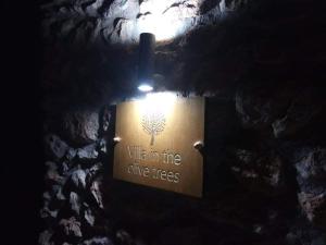a light on a wall with a tree on it at Villa in the Olive Trees in Galaxidhion