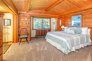 a bedroom with a bed and a chair in a cabin at Almost Paradise in Bodega Bay