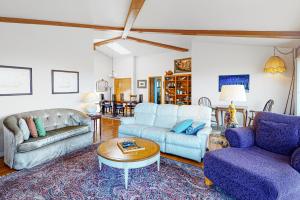 a living room with two couches and a table at Pinnacle Heights in Bodega Bay
