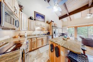 a kitchen with wooden cabinets and a large island at Durango Tango & Suite Studio in Durango