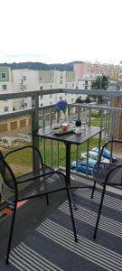 a table and two chairs on a balcony at Apartmán Dvojka in Náchod