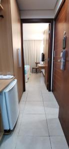 a hallway of a hotel room with a bathroom at Blanco Beach Suite Privada, Cumbuco in Cumbuco