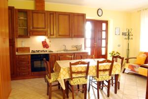 a kitchen with a table and chairs in a room at B&B Da Franca in Camporgiano