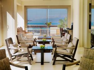 a living room with chairs and a table and a couch at H10 Gran Tinerfe - Adults Only in Adeje