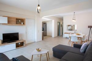 a living room with a couch and a table at Kymata Apartment Ierapetra in Ierápetra