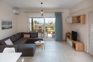 a living room with a couch and a table at Kymata Apartment Ierapetra in Ierápetra