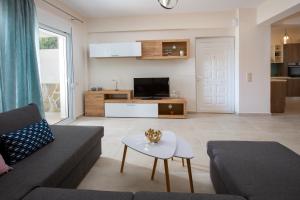 a living room with a couch and a table at Kymata Apartment Ierapetra in Ierápetra