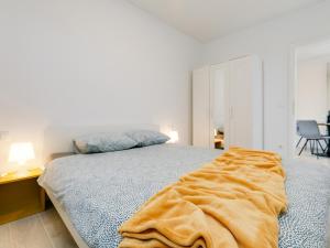 a bedroom with a bed with a blanket on it at Apartment Aria in Poreč