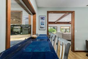 a dining room with a blue table and chairs at Garibaldi Getaway in Garibaldi