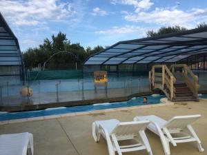 a swimming pool with a slide and a playground at camping marvilla parks 4 etoiles in Aureilhan
