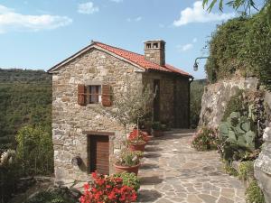 a small stone house with flowers in front of it at Apartment Villa Istriana in Koper