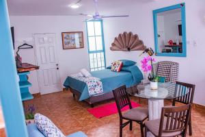 a bedroom with a bed and a table and chairs at Casa Cardennal in San Miguel de Allende