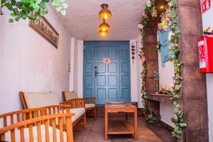 a living room with a blue door and chairs at Casa Cardennal in San Miguel de Allende