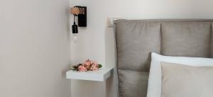 a bed with a nightstand with pink flowers on it at Le casette in Monopoli