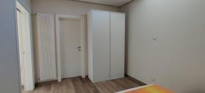 an empty room with white walls and wooden floors at Le casette in Monopoli