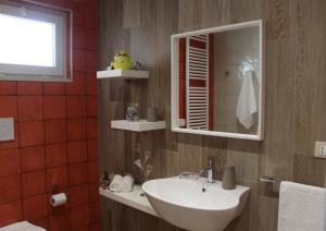 a bathroom with a sink and a mirror at Le casette in Monopoli