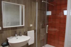 a bathroom with a sink and a shower at Le casette in Monopoli