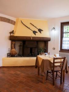 a dining room with a table and a fireplace at Agriturismo Cascina Costa in Cassago Brianza