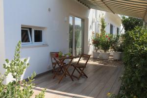a patio with a table and chairs on a porch at Le casette in Monopoli