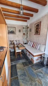 a living room with a couch and a table at Aegean Wave - Faros in Loutraki