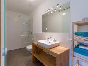 a bathroom with a sink and a shower and a toilet at Villa Grete, St. Johann in Tirol in Sankt Johann in Tirol +9 photos