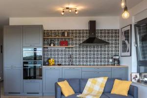 a living room with a blue couch in a kitchen at Apartment Emarin in Banjole