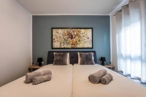 a bedroom with a large white bed with two pillows at Apartment Emarin in Banjole +25 photos