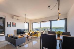 a living room filled with furniture and a large window at Apartment Emarin in Banjole