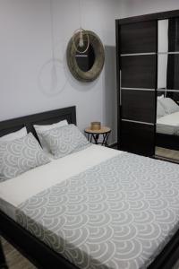 a bedroom with a large bed and a mirror at Zen Luxury Living in Thessaloniki