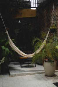 a hammock hanging in a room with plants at La Casa del Totumo in Santa Marta