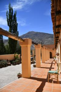 a porch of a house with a mountain in the background at Hosteria la granja in Huacalera