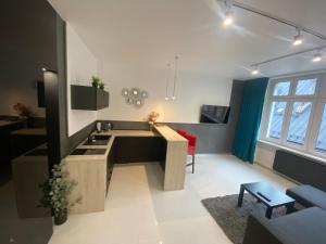 a kitchen with a sink and a table in a room at Apartamenty Planeta in Bielsko-Biała