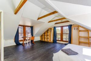 an attic bedroom with a bed and a table at Kana guest farm - 35 rooms for 70 guests in Stellenbosch +48 photos