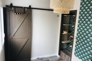 a sliding barn door in a wine cellar at Appartement 2/3 pers, centre ville avec parking. in Saint-Brevin-les-Pins