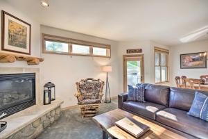 a living room with a leather couch and a fireplace at Breckenridge Condo with Hot Tub Less Than 1 Mi to Ski Lifts in Breckenridge