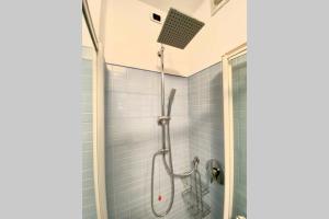 una doccia in un bagno con piastrelle blu di Boutique apartment in Milano center: Duomo Scala a Milano Altre 8 foto