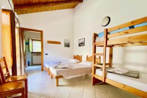 a room with two bunk beds and a mirror at Rifugio Escursionistico La Ruà in Macra