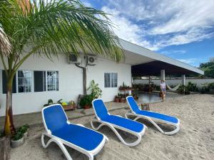 a group of blue chairs in front of a building at Casa Greca in Playa Blanca