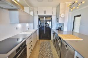 a kitchen with white cabinets and a counter top at 18 Storm Sea in Agulhas