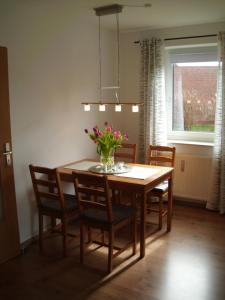 キュールングスボルンにあるPenzenstadlerのダイニングルームテーブル(椅子付)、花瓶