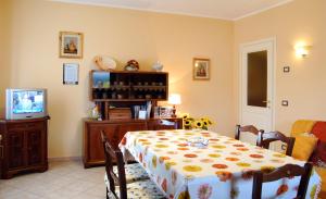 a dining room with a table and a tv at B&B Da Franca in Camporgiano