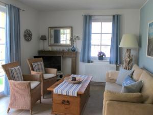 a living room with a couch and a coffee table at Wiesenstraße 55 Whg 1 - Meeresbrise in Zingst