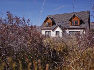 a house sitting on top of a hill at Highland Stays - Ben View Double Rooms in Fort William