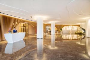 a man standing in a lobby with a white couch at Argyle Resort Dali Yueyun in Dali +70 photos
