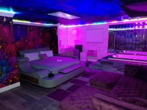 a purple room with a bed and a couch at Americas Best Value Inn Providence-North Scituate in North Scituate